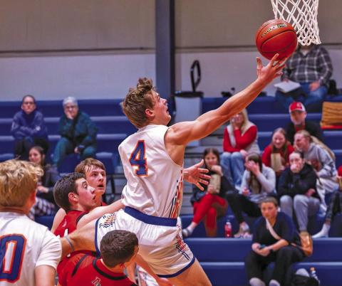 (Photo by Richae Malara) Senior Daniel Martins goes through the Ainsworth defenders for a lay-up on Saturday, December 6. Martins led the Mustangs with 26 points in the winning effort.