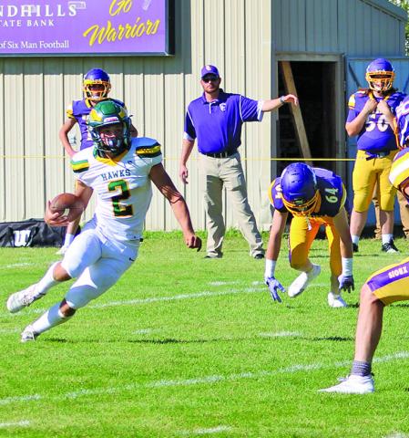 (Photo by Jessica Mintken) Junior Tripp Buettner breaks into the open field against the Sioux County Warriors on Friday, September 26. Buettner and the Hawks would roll, 75-38, for their third win of the season.