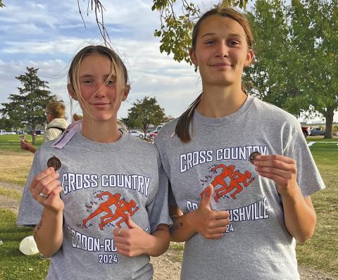 Photo by Amy Schmidt Kynsleigh Krebs (left) and Ashlyn Dehning (right) each medaled and earned a trip to State XC this Friday.