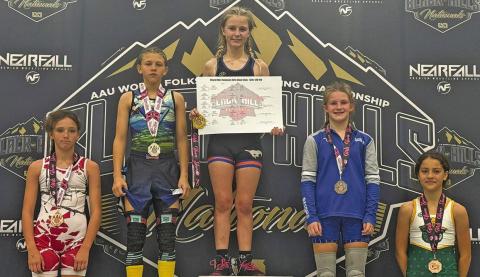 (Courtesy Photo) Gordon resident Brayzee Rawles stands atop the podium at the Black Hills Nationals Girls Glam Slam. Rawles took home the top prize in the 12U 100 lb. bracket. Rawles competed against the best of the best at the event which took place on Saturday, October 11.