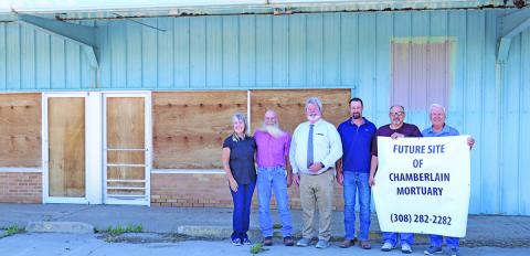 (Photo by Scott Bidroski) A property that has long been empty on the north side of Gordon has new owners. Chamberlain Mortuary purchased the property from Joe and Rosana Kirk and has plans to renovate the building to suit their needs. Pictured in the photo include: (L-R) Rosana Kirk, Joe Kirk, Jeff Chamberlain, Thomas Chamberlain, Harlen Wheeler, and Larry Turnbull.