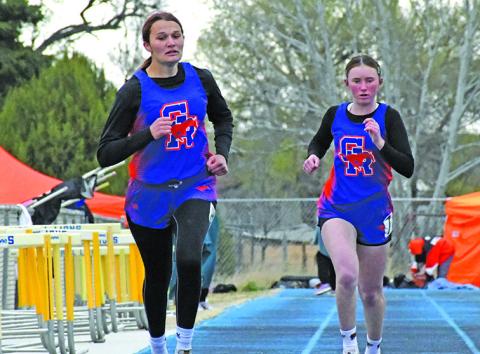 Photo by Melissa Grover Mustang sophomore Ashlyn Dehning and freshman Kynsleigh Krebs both push for the finish line during the Western Trails Conference Track Meet in Morrill on Thursday, April 17.