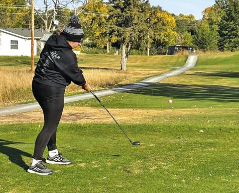 Photo by David Morris Senior Katie Coomes tees off during the State Golf Tournament held on October 16 and 17 in North Platte, Neb.