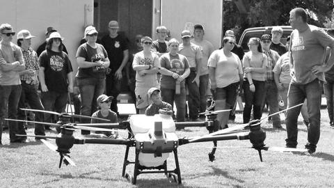 Photo by Chabella Guzman Dan Fitts, far right, farmer and drone operator, gives a talk and demonstration during the 2023 PARTT event in August at the UNL Panhandle Research Extension and Education Center in Scottsbluff.