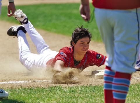(Photo by Richae Malara) Freshman Kendall Lebeau slides safely into third base during the Gering Tournament this past weekend. Lebeau and the Regulators went 2-2 over the 4 game tourney.