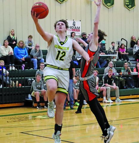 Photo by Scott Bidroski Junior Hunter McDonald goes up for two against Cody-Kilgore. McDonald finished the contest with 19 points in the Hay Springs win.