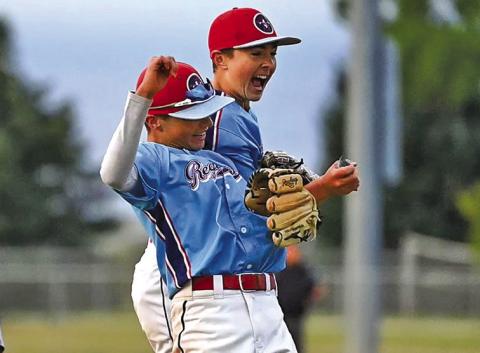 (Photo by Richae Malara) Eighth graders Liam Keracik and Khai Janssen celebrate a big strikeout that finished an inning against Orchard Tri-County.