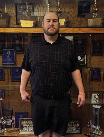 Photo by Tessa Hurlburt Darren Probst, the new Athletic Director for GRHS, standing in front of the trophy case at GRHS. He hopes to see the Mustangs have successful seasons this year.