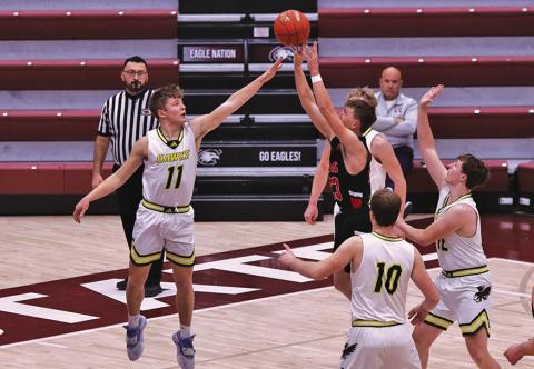 Photo by Scott Bidroski Senior Gage Mintken goes up for a block against Crawford. Mintken finished his career ranked third all-time in Hawks scoring with 1,189 points.