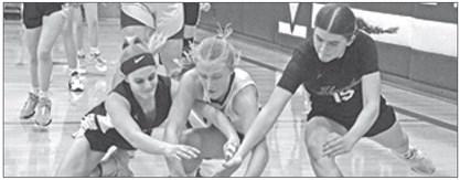 Photo by Jessica Mintken Hawks sophomores Andi Twarling (left) and Julia Russell (right) dive for the loose ball against Garden County.