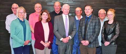 (Photo by Scott Bidroski) The First National Bank of Gordon Board of Directors takes a photo during their March meeting. Will Isham, center, is transitioning from his role as President of the bank into retirement but will still lead the Board of Directors. Pictured include: Randy Schmidt, Anita Brewer, Randy Langemeier, Brooke Gates, Troy Roth, Isham, Pat Riggleman, Cornelius Ray, Jim Smith, and Lacey Swayne.