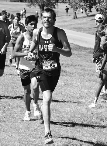 Photo by Chris Heiser Junior Mason Albrecht stays ahead of a few competitors during the Alliance Cross Country Invite on September 21.