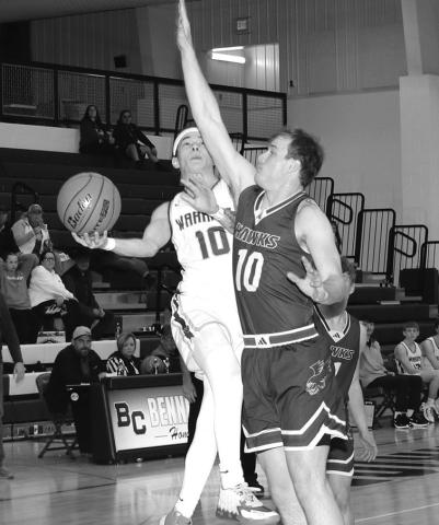 Photo by Taylor Risse, Bennett County Booster Senior Jordyn Anderson goes for the block against the Bennett County shooter. The Hawks would hang on for the win, 68-66.