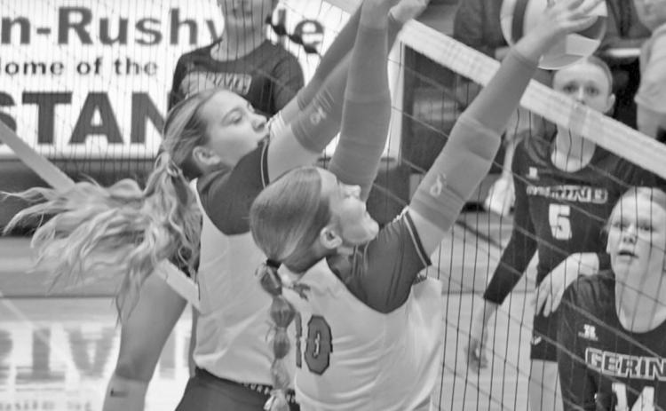 Photo by Michele Heck Mustangs Taleigh Starr and Emma Martins go up for a block against the Gering attackers on October 15.