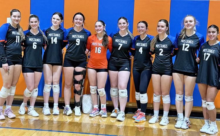 (Photo by Michele Heck) Ten seniors put on the orange and blue for the final time as Mustang Volleyball players. Here is the group pictured after their final home match.