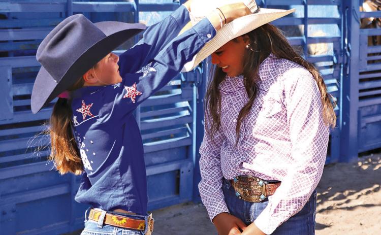 (Photo by Scott Bidroski) Kamille Kruger (right), pictured here with outgoing Princess Tenley Ostrander, was crowned the 2025 SCF&amp;R Princess at the Junior Rodeo on Sunday, July 20. Kruger will now carry the title for the next year and represent Sheridan County at rodeo events throughout her tenure.