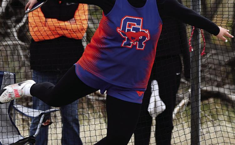 Photo by Melissa Grover McKinley Grover launches the discus for her second gold medal on the day to punch her ticket to the NSAA State Track Meet at Burke Stadium in Omaha, Neb.