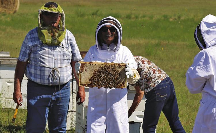 Photo Courtesy of Senator Deb Fischer’s Office Nebraska State Senator Deb Fischer snaps a photo while working bees with Hay Springs resident Ed McDonald on Tuesday, August 12. Fischer as in town to visit with the McDonald’s about their independent, wholesale beekeeping business that has been operating for 37 years.