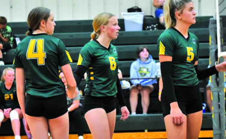 Courtesy Photo Kya Binger, Reese Varvel, and Julia Russell await the serve from Banner County on September 3.