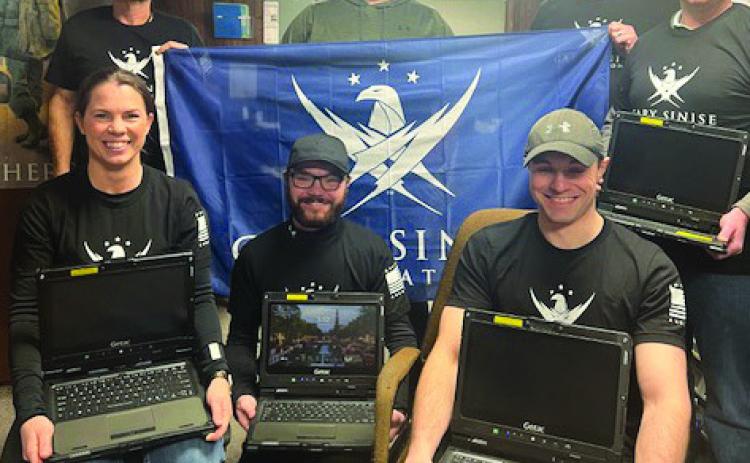 Courtesy Photo Police Chief Clay Heath holds banner for the Gary Sinise Foundation that helped provide funding for some of the new equipment recently purchased for the Gordon PD, including the new rugged G-tech laptops pictured here.