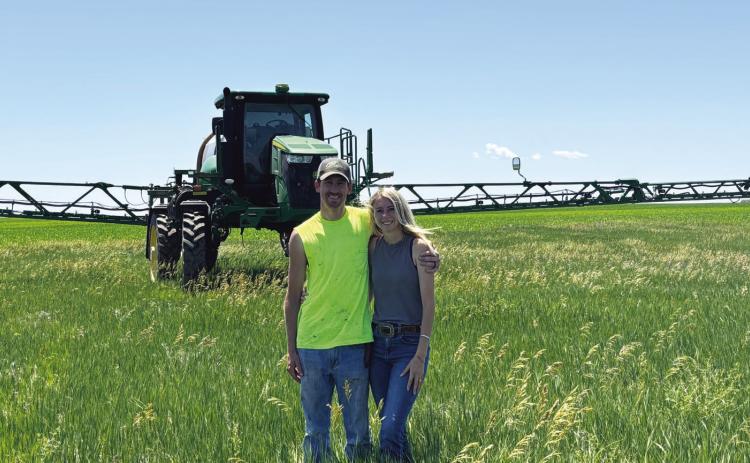 (Photo by Lisa Hare) Marc and Halley Sandberg of Hay Springs work their farm together, utilizing John Deere’s GreenStar Technology for much of the management for their operation.