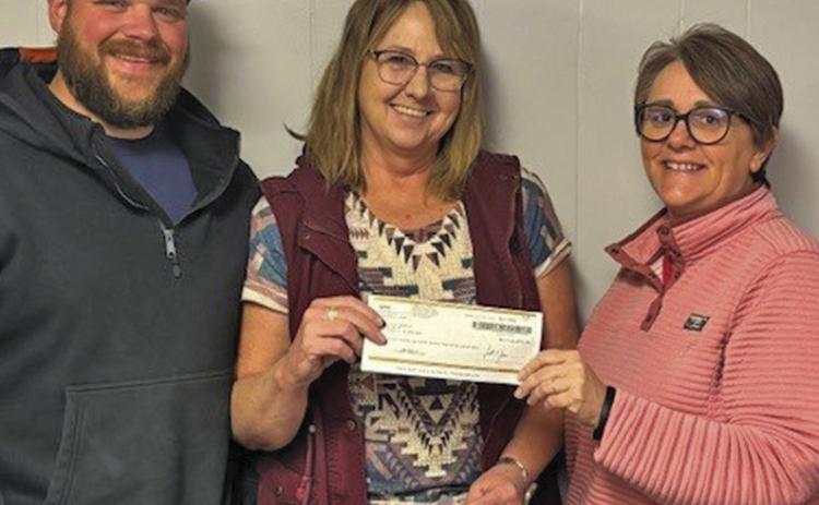 (Courtesy Photo) City of Rushville Superintendent in Training Logan Colwell (left) and Rushville Mayor Amanda Haller (right) receive a check for $14,273.50 from Security First Insurance Managing Agent Phyllis Lindsey.