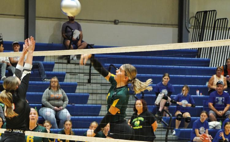Photo by Michele Heck Junior Julia Russell fires a shot against Crawford at the G-R Quad on Saturday, September 14. The Hawks would win the match against the Rams 2-0.
