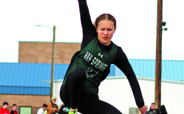 Photo by Scott Bidroski Freshman Alaina Raymer soars to her mark in the Long Jump. Raymer finished in seventh place in the event at the Chadron Twilight meet on Friday, April 19.