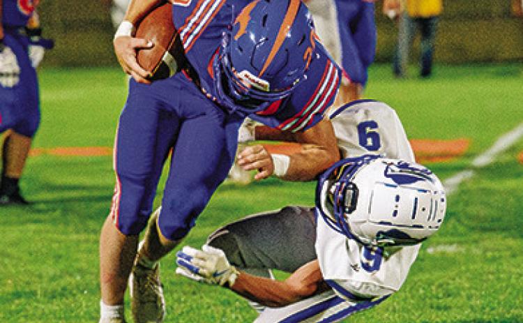 Photo by Morgan Meisenheimer Senior Kyler Vincent runs over a Gibbon defender en route to a big gain for the Mustangs. Vincent finished his evening with 124 yards and 2 touchdowns.