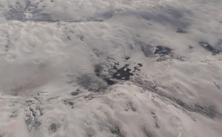 (Photo by Les Hare) A recent aerial photo taken 7,000 feet above the tragic remains of a wide expanse of the Sandhills reveals mile after mile of bare and blowing sand in the aftermath of the wildfires that ravaged more than 800,000 acres.