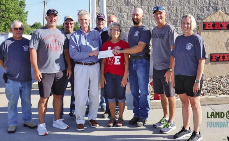 Photo by On Thursday, June 19, members of the Hay Springs Fire Department along with representatives from WESTCO presented a $40,000 check in honor of the late Randy Turman. Those pictured included: (L-R) Tim Fetter, Jeff Turman, Jerry Turman, David Briggs, Keith Kearns, Everett Langford, Betty Turman, Cole Wyatt, Ryan Turman, and Holly Scherbarth.