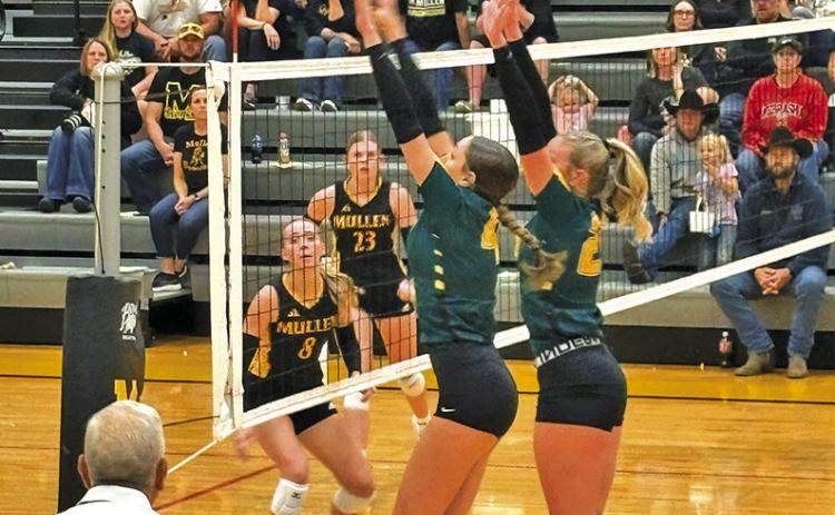 Photo by Jim Varvel Senior Mya Turman and sophomore Devyn Young go up for the block against Mullen on Friday, Sept. 5.