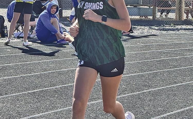 (Photo by Jessie Anderson) Freshman Tabby Schiaffo rounds the corner during the Mitchell Invite on Thursday, April 9.
