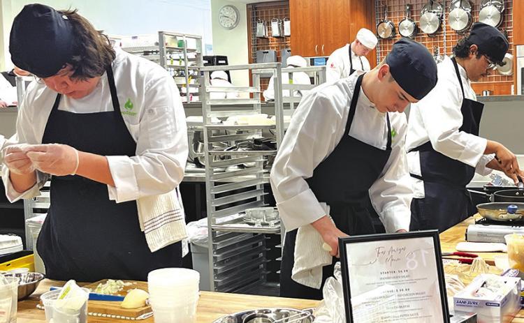 Photo by Kay Kruger Gordon-Rushville ProStart team Tres Leches works tediously on their dish for the State Final Three competition in Omaha, Neb. on March 15. Pictured are team members Seth Mills, Tristin Costello, and Juan Montenez-Rodriguez.