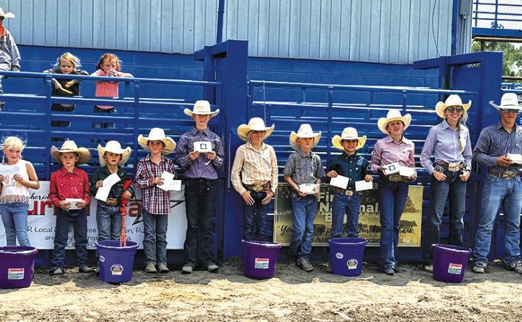 Photo by Courtney Ostrander The participants lined up following all the events during the 2024 Junior Rodeo to show off the hardware they earned in the arena. Those pictured include: (L-R) Myah Burress, Brookley Peters, Connor Peters, Weston Rahn, CoBurn Morrison, Payton Burress, Shaylee Grant, Truett Kearns, Tru Mundorf, Audrabell Werth, Sutten Parkison, Matthew Lein, and Bentley Ford.