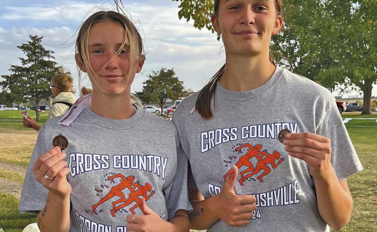 Photo by Amy Schmidt Kynsleigh Krebs (left) and Ashlyn Dehning (right) each medaled and earned a trip to State XC this Friday.