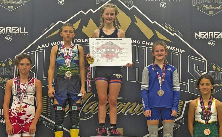 (Courtesy Photo) Gordon resident Brayzee Rawles stands atop the podium at the Black Hills Nationals Girls Glam Slam. Rawles took home the top prize in the 12U 100 lb. bracket. Rawles competed against the best of the best at the event which took place on Saturday, October 11.