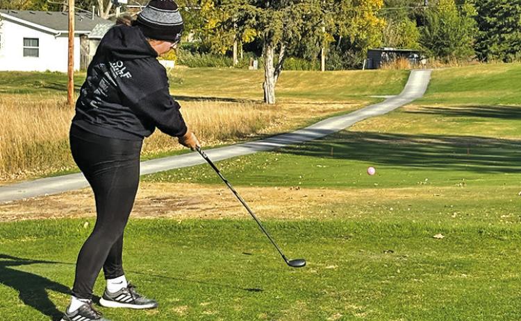 Photo by David Morris Senior Katie Coomes tees off during the State Golf Tournament held on October 16 and 17 in North Platte, Neb.