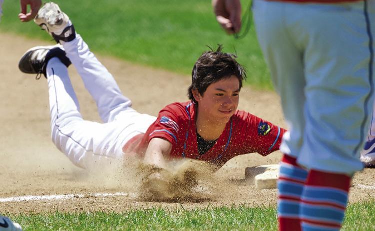 (Photo by Richae Malara) Freshman Kendall Lebeau slides safely into third base during the Gering Tournament this past weekend. Lebeau and the Regulators went 2-2 over the 4 game tourney.