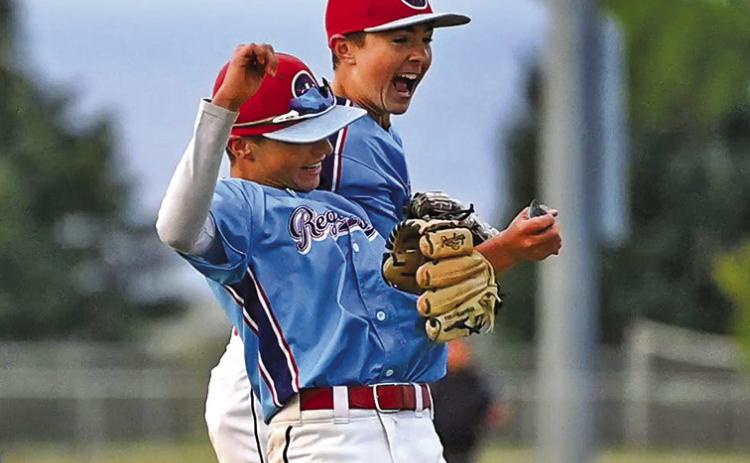 (Photo by Richae Malara) Eighth graders Liam Keracik and Khai Janssen celebrate a big strikeout that finished an inning against Orchard Tri-County.
