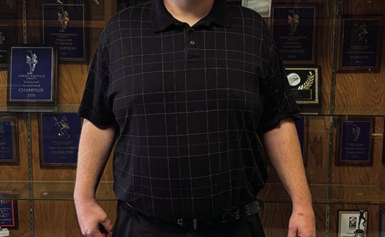 Photo by Tessa Hurlburt Darren Probst, the new Athletic Director for GRHS, standing in front of the trophy case at GRHS. He hopes to see the Mustangs have successful seasons this year.